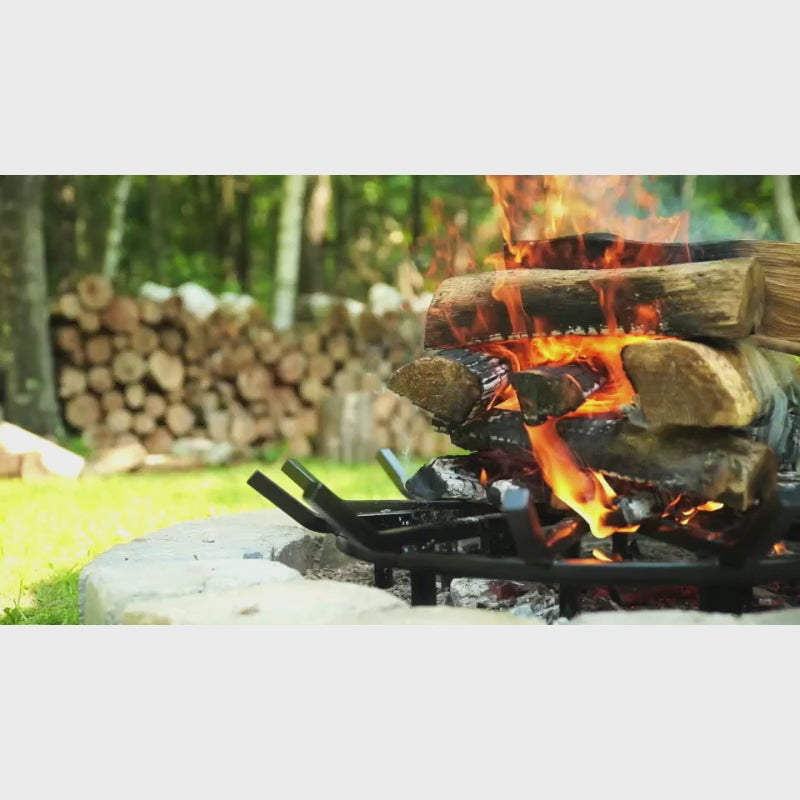 tall stacked firewood burning over wagone wheel style fire grate for better airflow and cleaner burn