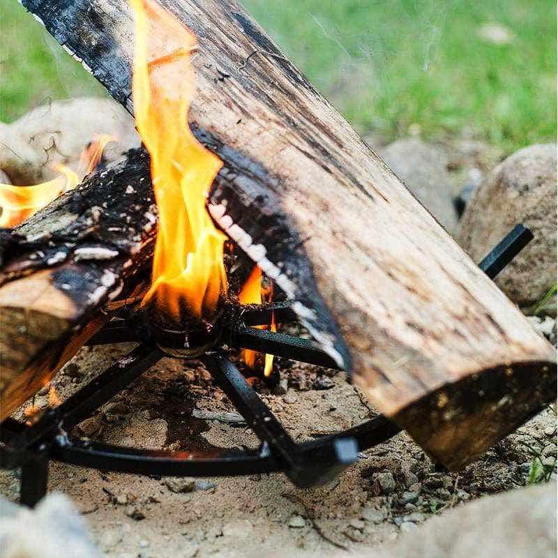 fire starter placed in center of grate burning tall to ignite firewood